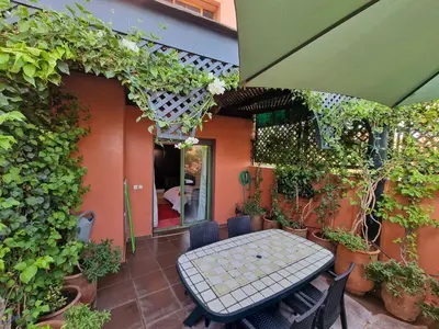 a patio with a table and chairs and plants at Elegant Gueliz Retreat near Majorelle in Marrakech