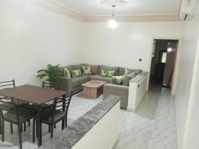 a living room with a couch and a table at Appart Atlas in Marrakech