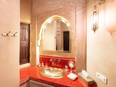 a bathroom with a sink and a mirror at Riad Selouane in Marrakech
