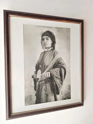 a black and white photo of a woman holding a bottle at Riad Sahara Nour in Marrakech