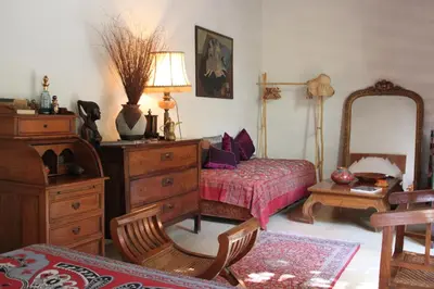 a bedroom with a bed and a dresser and a mirror at Riad Sahara Nour in Marrakech