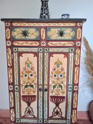 a colorful cabinet with an eiffel tower in the background at Riad Sahara Nour in Marrakech