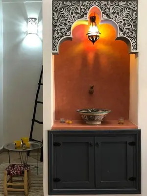 a bathroom with a black cabinet with a sink at Dar Christine in Marrakech