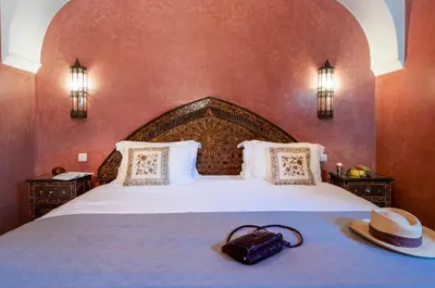 a bedroom with a large bed with a hat on it at Charming villa in the heart of Marrakech palm grove in Marrakech