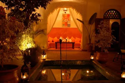 a living room with a couch and a table with lights at Riad Massiba in Marrakech