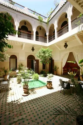 a building with a courtyard with a pool in it at Riad Massiba in Marrakech