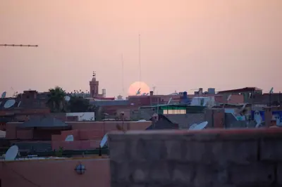 a city skyline with a clock tower in the background at Riad Massiba in Marrakech