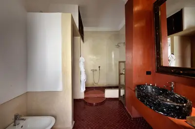 a bathroom with a sink and a bath tub at Riad les Ammonites and Spa in Marrakech