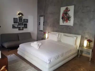a bedroom with a large white bed and a couch at Riad les Ammonites and Spa in Marrakech
