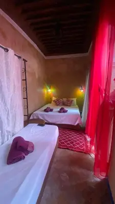 two beds in a room with red lights at RIAD DES DEUX MERS in Marrakech