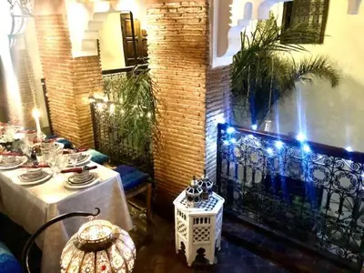 a room with two tables and a iron fence at RIAD DES DEUX MERS in Marrakech