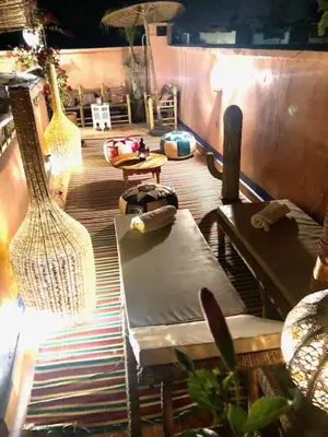 a living room with a bench and a guitar at RIAD DES DEUX MERS in Marrakech