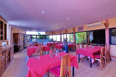 a restaurant with pink tables and chairs in a room at Hacienda Marrakech in Marrakech