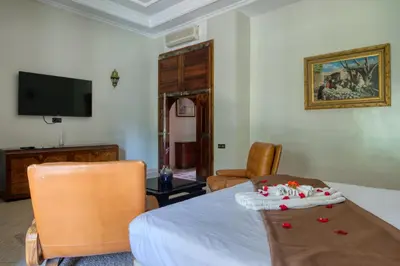 a living room with a table with a cake on it at Villas 95 Appart'Hôtel in Marrakech