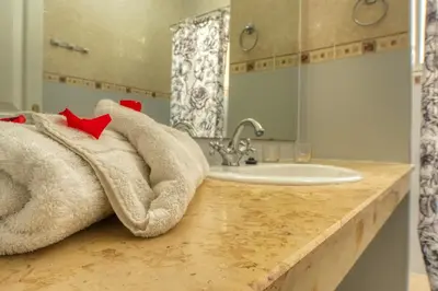 a bathroom with a towel on a counter with a sink at Villas 95 Appart'Hôtel in Marrakech