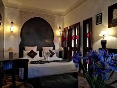a bedroom with a bed and blue flowers in a room at Riad Charme d'Orient Adults Only in Marrakech