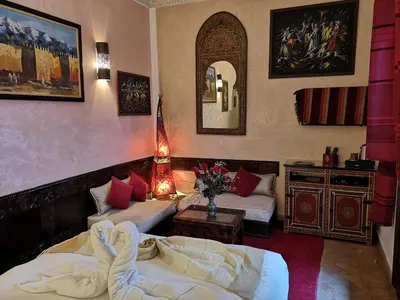 a living room with two beds and a mirror at Riad Charme d'Orient Adults Only in Marrakech