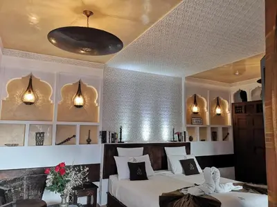 a bedroom with two beds and two lights at Riad Charme d'Orient Adults Only in Marrakech
