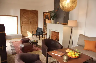 a living room filled with furniture and a fireplace at Riad Spa Dar Nimbus in Marrakech