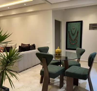 a living room with a table and a couch at Caprice Palace in Marrakech