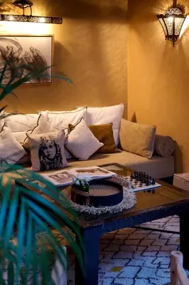 a living room with a couch and a chessboard on a table at Riad Dar Amanza en exclusivité avec 4 chambres au coeur de la médina in Marrakech