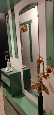 a bathroom with a mirror and a vase with a plant at Appart Piscine Jardin somptueux à 2 min de palmeraie et 10 min de Majorelle in Marrakech