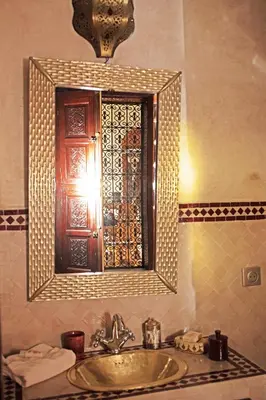 a bathroom with a sink and a mirror with a medicine cabinet at Riad Daria Suites & Spa in Marrakech