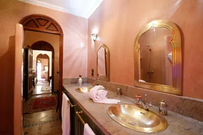 a bathroom with two sinks and two mirrors at Riad Daria Suites & Spa in Marrakech