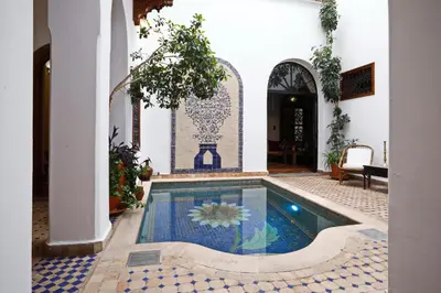 a house with a swimming pool in a courtyard at Riad Daria Suites & Spa in Marrakech