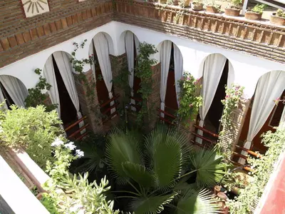 a garden with arches and plants on a building at Riad Laith in Marrakech