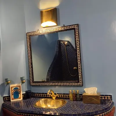 a bathroom with a sink and a mirror at Riad Laith in Marrakech