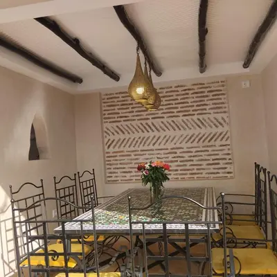 a dining room with a glass table and chairs at Riad Laith in Marrakech