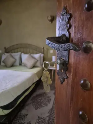 a door with a key in a bedroom with a bed at Riad Bianca Marrakech in Marrakech