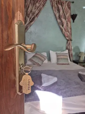 a door with a tag on it with a bed at Riad Bianca Marrakech in Marrakech