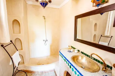 a bathroom with a sink and a tub at Hotel & Spa Riad Dar El Aila in Marrakech