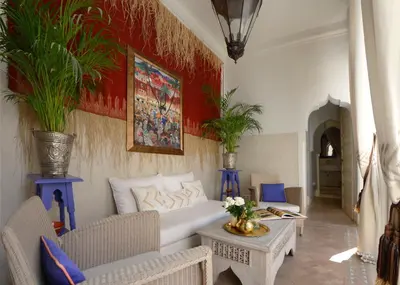 a living room with a white couch and a table at Riad Dar Housnia in Marrakech