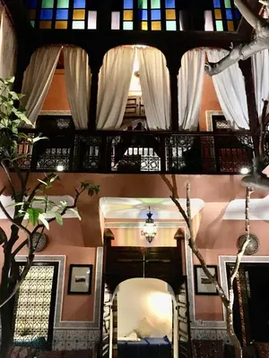 a view of a room with white curtains and a mirror at Riad Blue Berber in Marrakech