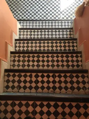 a set of stairs with black and white tiles at Riad Blue Berber in Marrakech
