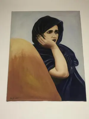 a painting of a woman in a black hijab at Riad Blue Berber in Marrakech