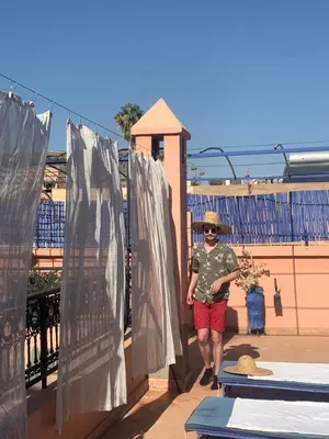 a woman is standing on a roof at Riad Blue Berber in Marrakech