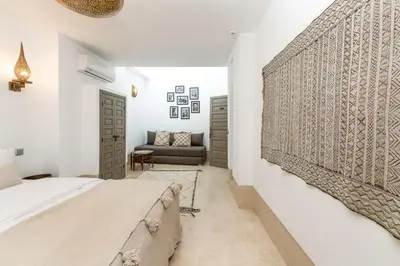 a bedroom with a bed and a couch at Riad Louhou in Marrakech