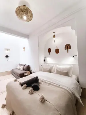 a bedroom with a large bed and a couch at Riad Louhou in Marrakech