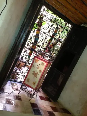 a stained glass window with a sign in front of it at Riad Mehdia & spa in Marrakech