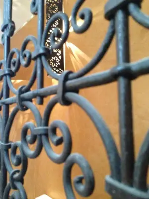 a black metal fence with a light on it at Riad Mehdia & spa in Marrakech