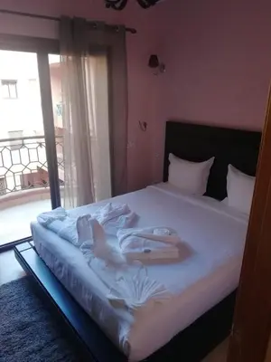 a bedroom with a bed with towels on it at LINA APPARTEMENT in Marrakech