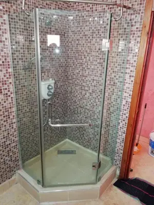 a shower with a glass door in a bathroom at LINA APPARTEMENT in Marrakech