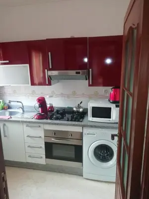 a kitchen with a stove and a microwave at LINA APPARTEMENT in Marrakech