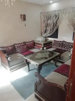 a living room with a couch and a table at LINA APPARTEMENT in Marrakech