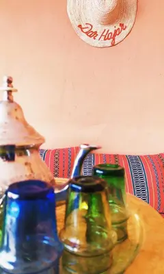 a table with three different colored jars on it at Dar HAJAR in Marrakech