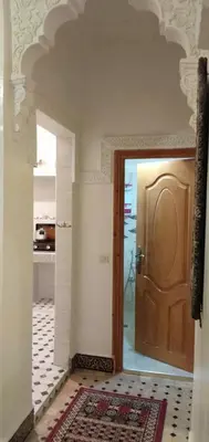 a hallway with a door and a room with a rug at Dar HAJAR in Marrakech